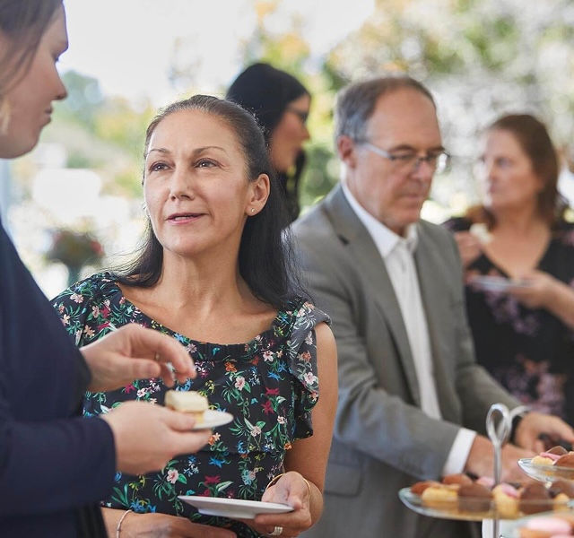 funeral director serving food and drinks